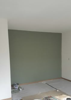 an empty room is being painted green and white