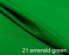 green fabric with the words emerald green on it and an image of two different colors