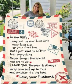 a woman is holding up a blanket that has stamps on it and the words to her husband