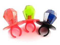 three different colored plastic hair clips on a white background