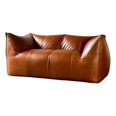 a brown leather couch sitting on top of a white floor