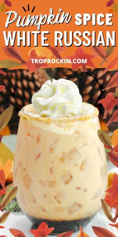 pumpkin spice white russian dessert with whipped cream on top and leaves around the rim, in front of an orange background