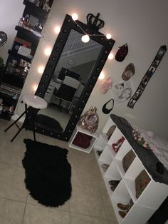 a room with a mirror, shelves and lights