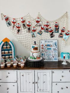 a table topped with lots of cupcakes and cakes