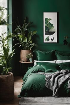 a bed with green sheets and pillows in a room next to a potted plant