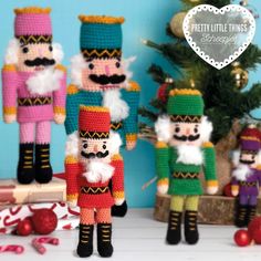 three crocheted nutcrackers are standing next to a christmas tree