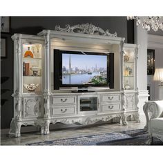 an ornate white entertainment center in a living room