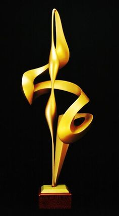 a golden sculpture is shown on a black background