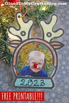 a christmas ornament with a baby's face in the center and a red nose