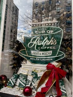 there is a display in the window of a coffee shop that has been decorated for christmas