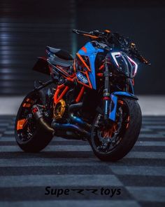 a blue and orange motorcycle is parked on the street