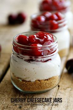 cherries are placed in small jars on a table