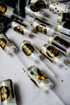 several clear tubes with black and gold designs on them