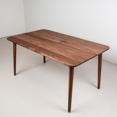 a wooden table sitting on top of a white floor