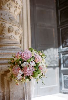 a vase filled with pink and white flowers