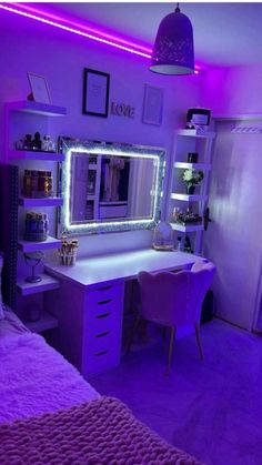 a bedroom with purple lights on the wall and a white desk topped with a mirror