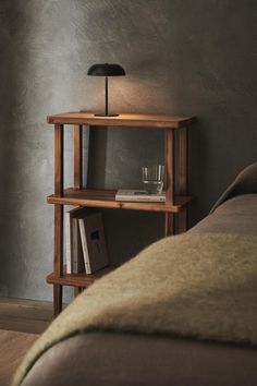 a wooden shelf with a lamp on top of it