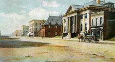 an old photo of a horse and buggy on the street