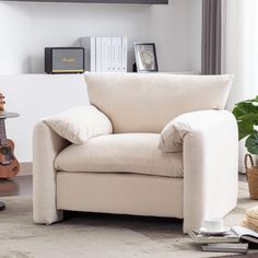 a living room with a white couch and guitar