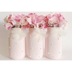 three pink mason jars with flowers in them