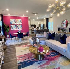 a living room filled with lots of furniture and pink walls in the backround