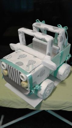 a cake made to look like a jeep with bows on the front and back wheels