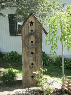 a birdhouse made out of wood with stars on it