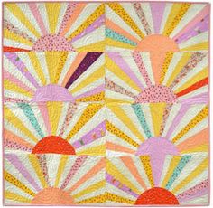 a colorful quilt with sunbursts on it