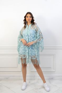 (SALE ITEM - FINAL SALE)Featuring: Floral Lace Fringe sleeves Unlined Bell sleeves Band collar Color: Tiffany blue.Brand: Unmatched BYU.Match it with a slip dress - The model is wearing a baby blue mini slip dress (Shop slip dresses)Size: Free Size. "fits sizes between 2 (US) up to 24 (US)"Exact Caftan Measurements: Bust: 52 (Inches)Hem: 63 (Inches)Length: 32.5 (Inches)This caftan is available in multiple colors Spring Beach Cover-up Dress With Tassels, Elegant Long Sleeve Dress For Beach Cover-up, Spring Kaftan With Tassels And Kimono Sleeves, Elegant Long Sleeve Kaftan With Tassels, Blue V-neck Kaftan For Party, Light Blue Long Dresses For Spring, Long Light Blue Spring Dress, Evening Kaftan With Tassels, Long Sleeve Spring Kaftan With Tassels