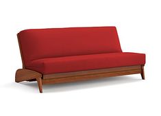 a red couch sitting on top of a wooden frame