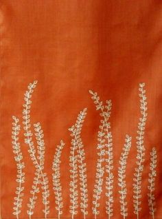 an orange cloth with white flowers on it