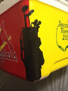 a close up of a yellow and red cooler with a st louis logo on it