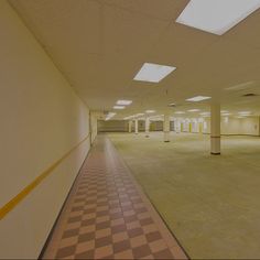 an empty parking garage with checkered tile flooring