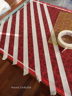 the table is covered in red and white striped fabric, with tape on top of it