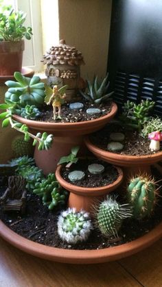 three tiered planters filled with succulents and plants