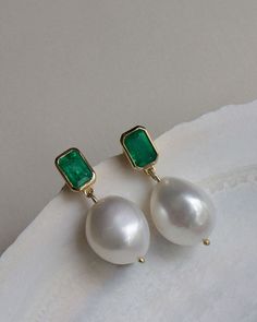 These earrings feature one-of-a-kind baroque pearls and Zambian emeralds. Baroque pearls are naturally formed and each is unique. Our emeralds are 100% natural, meaning they're not dyed or heat treated. No stone is exactly alike. 14k solid gold—always. Weight: 3g per earring Carat weight: 0.5cw per earring Stone Measurements: 6mm x 4mm Pearl Measurements: Approx 13mm x 12mm Pearl & Emerald Care: Pearls and emeralds are not meant to be worn in the shower. To extend the life of your piece, we reco Pearl Emerald Earrings, Green Gemstone Pearl Drop Earrings, Green Gemstone Drop Pearl Earrings, Elegant Green Pearl Earrings With Charm, Elegant Green Pearl Charm Earrings, Emerald Earrings With Pearl Drop For Gift, Green Emerald Earrings With Pearl Drop, Green Pearl Drop Earrings, Pearl Drop Earrings For May Birthstone