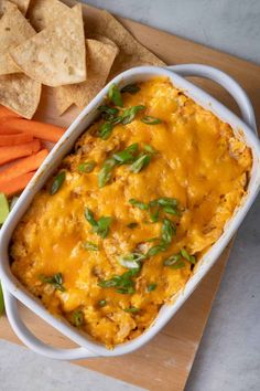 a casserole dish with carrots, celery and tortilla chips