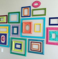 there are many different colored frames on the wall