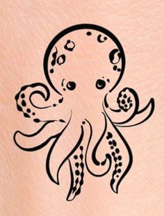 an octopus tattoo design on the back of a woman's stomach, with black ink