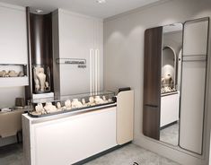 a kitchen with white cupboards and counter tops in front of a large mirror on the wall