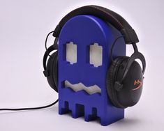 a blue headphone holder with two headsets on it's sides and an ear muffs attached to the back