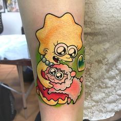 a woman with a tattoo on her leg that has an image of a cartoon character