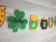 st patrick's day banner with shamrocks and beer mugs hanging on a string