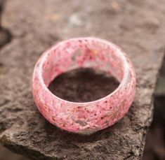 Unusual Ring made of Wood and Epoxy Resin with flowers Sakura| Handmade High Quality Wooden Beautiful Epoxy Ring| Unick Ring| Nature Ring Materials: wood,  jewelry resin, epoxy resin, dried flowers size: Inner diameter from 15 to 23 mm The Sakura ring is made of transparent resin and small pink dried flowers. Sakura blooms from the end of March, and until May, in different areas of Japan in different ways. This period is called Hanami -- admiring sakura. For the Japanese, cherry blossoms are a m Resin With Flowers, Sakura Ring, Pink Dried Flowers, Flowers Sakura, Epoxy Ring, Resin Dried Flowers, Japanese Cherry Blossoms, Sakura Bloom, Edgy Jewelry