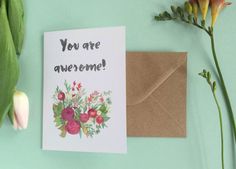 a card that says you are awesome with flowers on it next to a flower bouquet