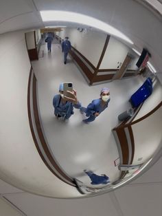 two doctors in scrubs are walking down the hall