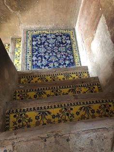 some yellow and blue steps with tile on them