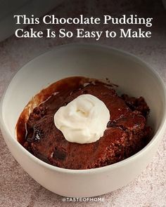 a white bowl filled with chocolate pudding and whipped cream on top of it's side