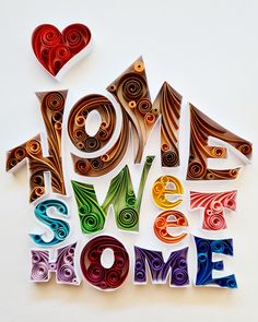 the words home sweet home are made out of colored paper and cut into shapes with hearts