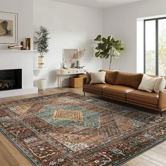 a living room filled with furniture and a large rug on top of a hard wood floor